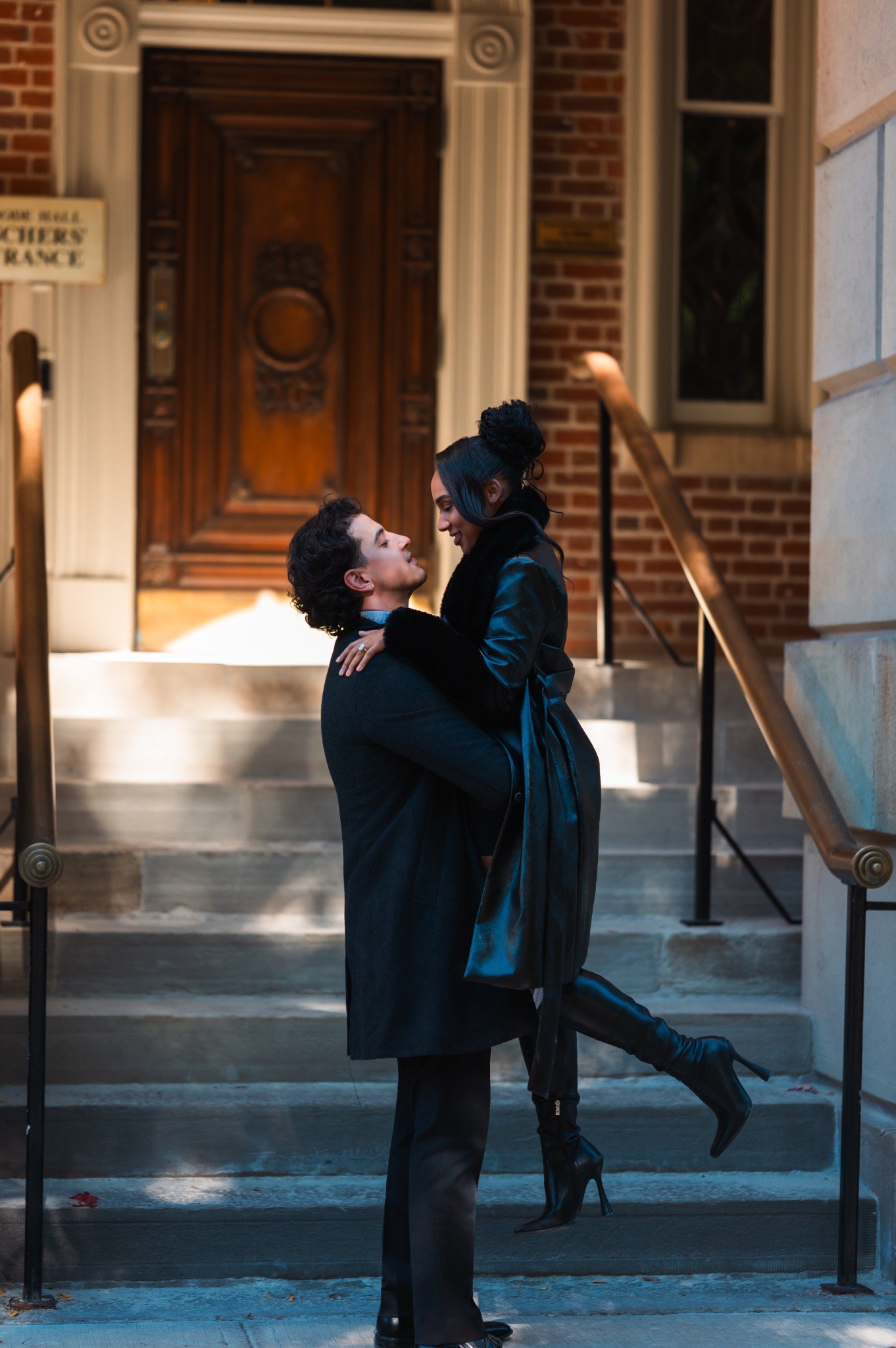 Anthony lifting Shadean on the steps during their engagement session